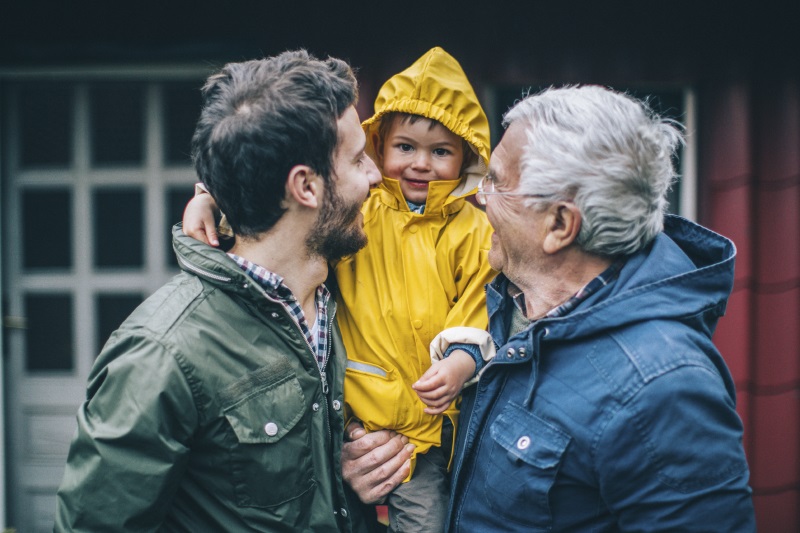 a photo of a grandfather and father holding a young boy